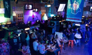 Photo of people enjoying retro arcade games during an evening at FlashBack RetroPub
