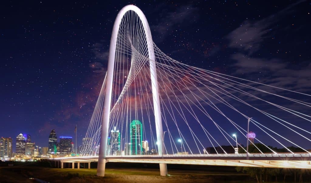 Photo of The Margaret Hunt Hill Bridge in Dallas, Texas, that spans the Trinity River illuminated on a winter night.