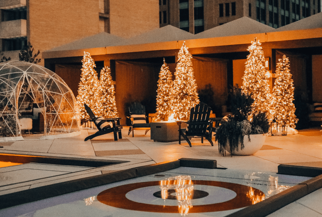 Photo of Christmas trees, an igloo and a curling rink on a Dallas rooftop