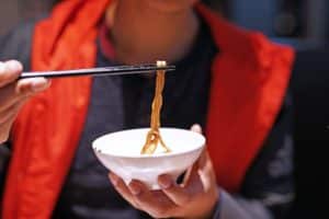 Noodles being eaten with chopsticks 