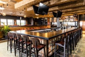 Bar with TVs and seating at Malai Kitchen in Dallas