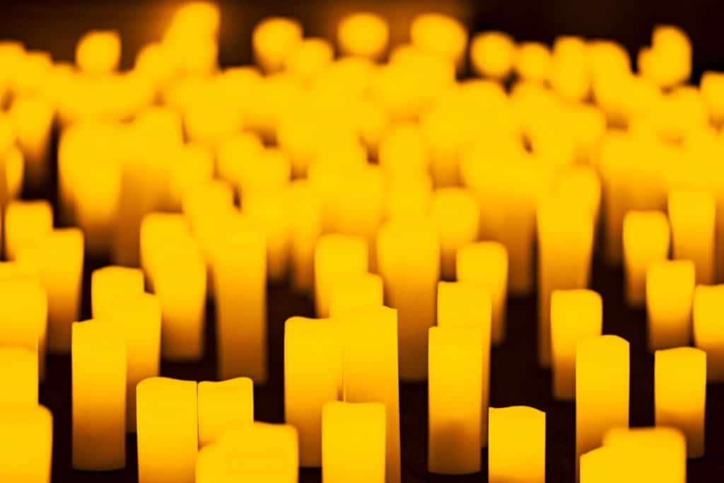A close up of a sea of candles